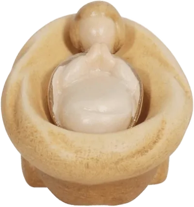 Hand-carved wooden Infant Jesus figure lying in a rounded manger, natural wood tones