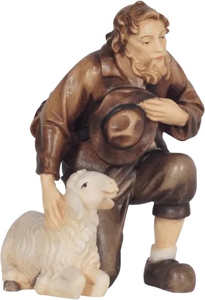 Hand-carved wooden shepherd kneeling with hat and sheep, painted in brown and cream tones